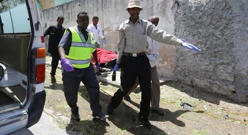Paramedics carry a civilian wounded following a car bomb claimed by al Shabaab Islamist militants outside the president's palace on a stretcher from the scene of the explosion in the Somali capital of Mogadishu, August 30, 2016. 
