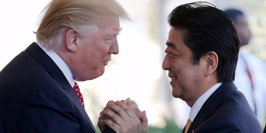 President Donald Trump (L) greets Japanese Prime Minister Shinzo Abe as he arrives at the White House on February 10, 2017 in Washington, DC.