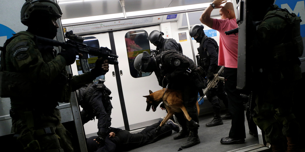 Brazilian military policemen of special-operations unit (BOPE) take part in an instructional exercise with officers of an elite unit of the French police, who are responsible for antiterrorist actions in France, ahead of the 2016 Rio Olympics at Rio de Janeiro's subway, June 10, 2016.