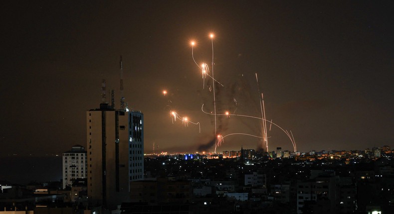 An Israeli missile launched from the Iron Dome defence missile system attempts to intercept a rocket, fired from the Gaza Strip, over the city of Netivot in southern Israel on October 8, 2023.MAHMUD HAMS/Getty Images