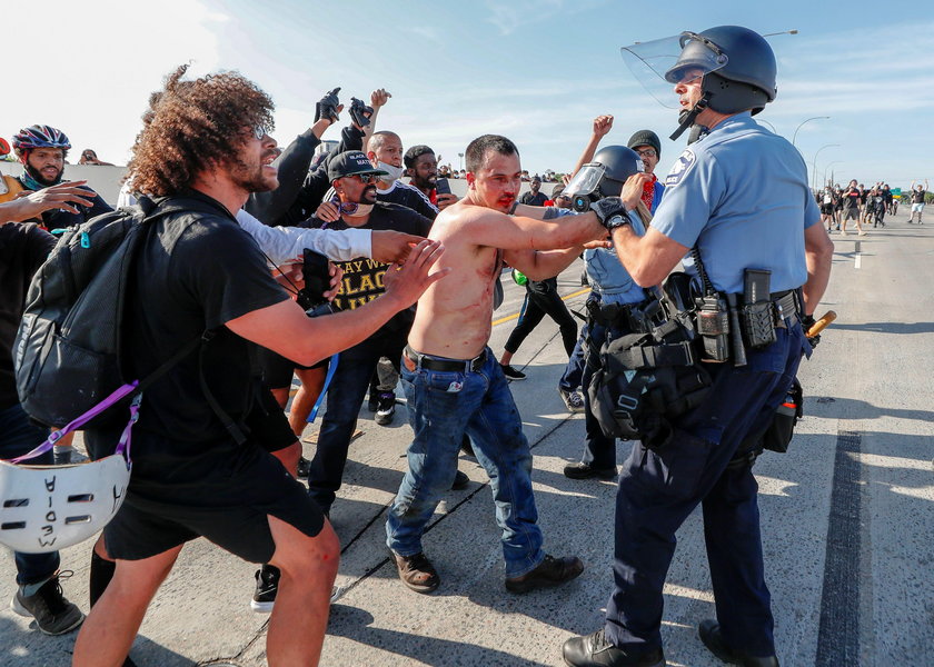 Protesters scale a truck that was driven into a rally