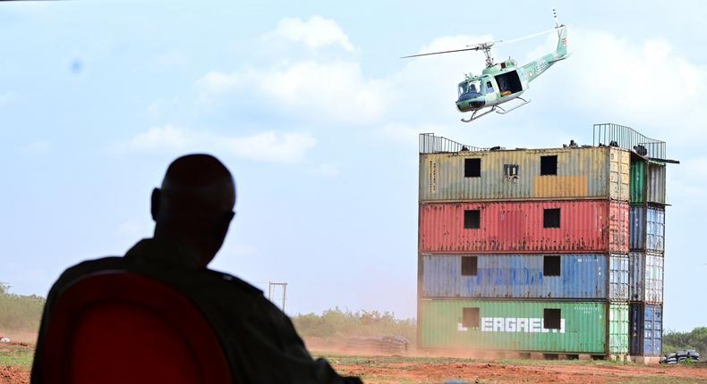 Museveni watches a chopper driill at the passing out event