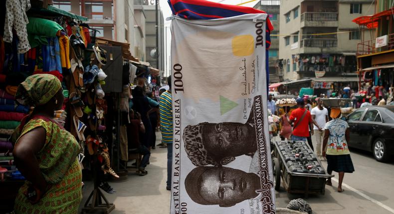 A towel with a print of the Nigerian naira is displayed for sale at a street market - February 4, 2016. REUTERS/Akintunde Akinleye/File Photo