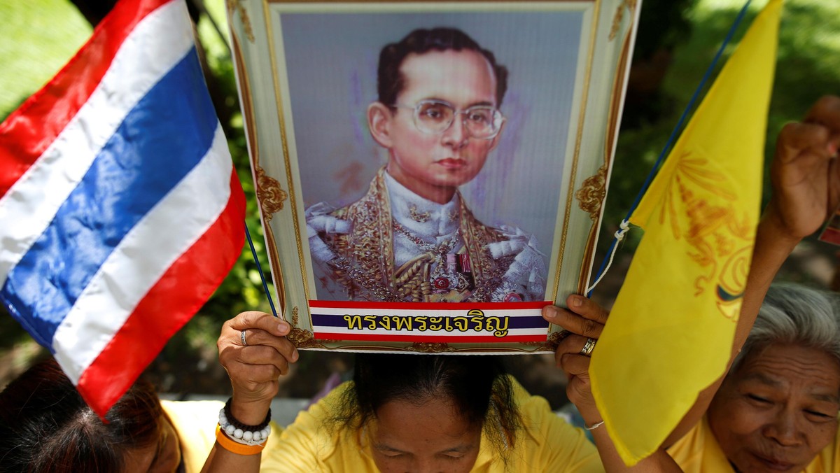 Well-wishers hold a picture of Thailand's King Bhumibol Adulyadej at the Siriraj hospital where he i