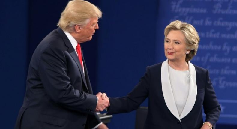 Hillary Clinton (right) and Donald Trump shake hands at the end of the second presidential debate in St. Louis, on October 9, 2016