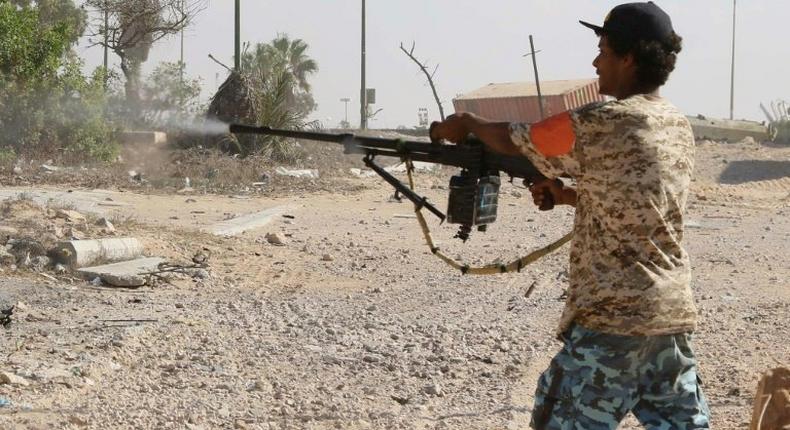 A Libyan pro-regime fighter with the Government of National Accord (GNA) fires at Islamic State jihadists during clashes for control of Sirte, on September 3, 2016