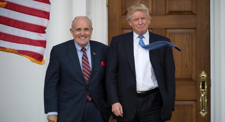 President-elect Donald Trump has confirmed that former New York City Mayor Rudy Giuliani (L) will not be joining his cabinet