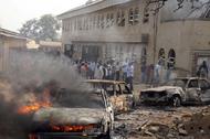 File photo shows a car burning at the scene of a Boko Haram bomb explosion at St. Theresa Catholic C