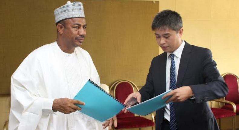 L-R: Secretary to Sokoto State Government (SSG), Professor Bashir Garba, exchanging signed documents with the Assistant Managing Director for Overseas Business of Kunming Engineering Corporation, Qui Haisheng, after the signing of MoU in Sokoto.