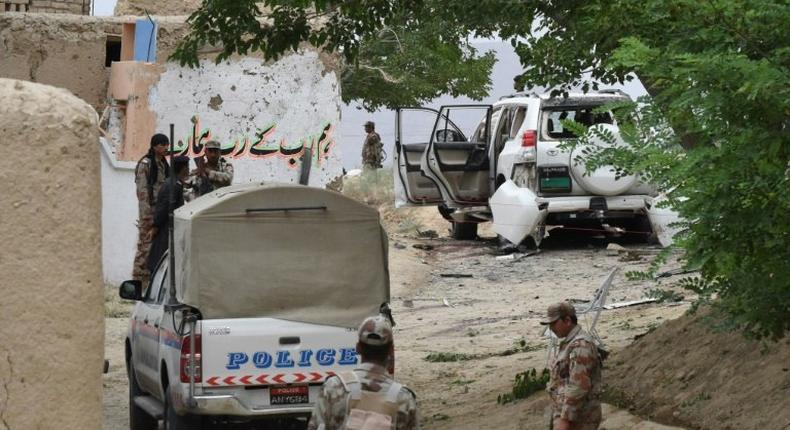 Pakistani security officials examine the site of a powerful explosion near Quetta on May 12, 2017