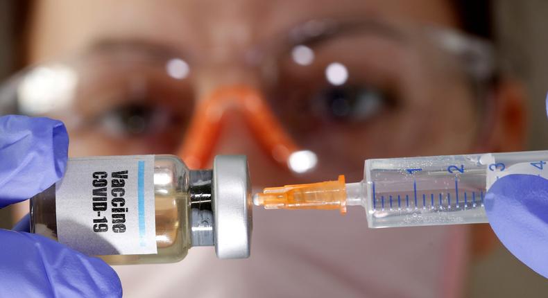 FILE PHOTO: A woman holds a small bottle labeled with a