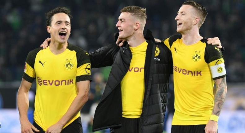 Borussia Dortmund midfielders Thomas Delaney (L), Jacob Bruun Larsen (C) and Marco Reus (R) celebrate Saturday's 1-0 win at Wolfsburg - a new club record of 15 games unbeaten - ahead of Tuesday's tough Champions League game away to Atletico Madrid.