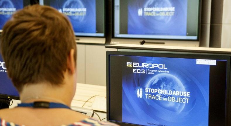 A Europol police agent looks at the onscreen logo of a new website launched by Europol at the Europol headquarters in The Hague on May 31, 2017