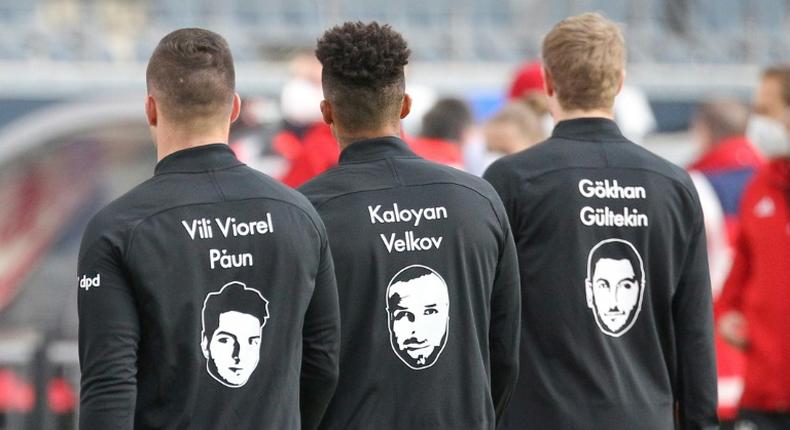 Frankfurt players wear shirts with names and portraits of victims of the Hanau shootings which took place one year ago