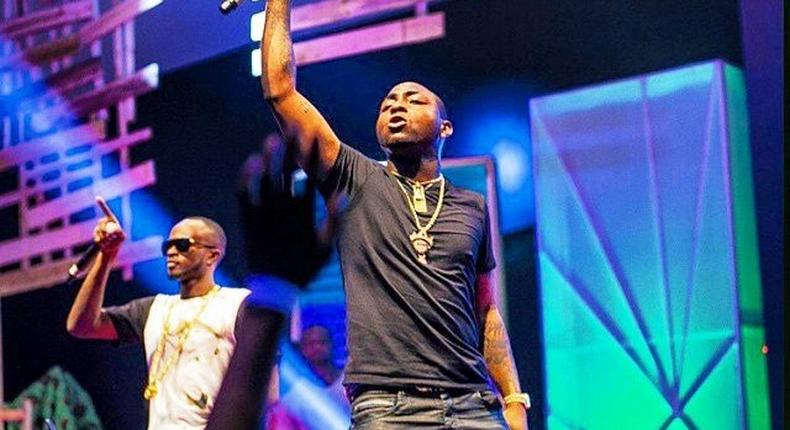 Davido and Danagog performing together at an event