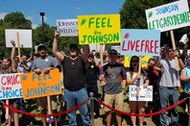 Supporters cheer at a campaign rally with Libertarian presidential candidate Johnson and vice presid