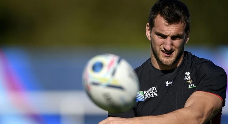 Wales' back row and captiain Sam Warburton catches the ball during a training session at the Hazelwood training centre in London on September 25, 2015