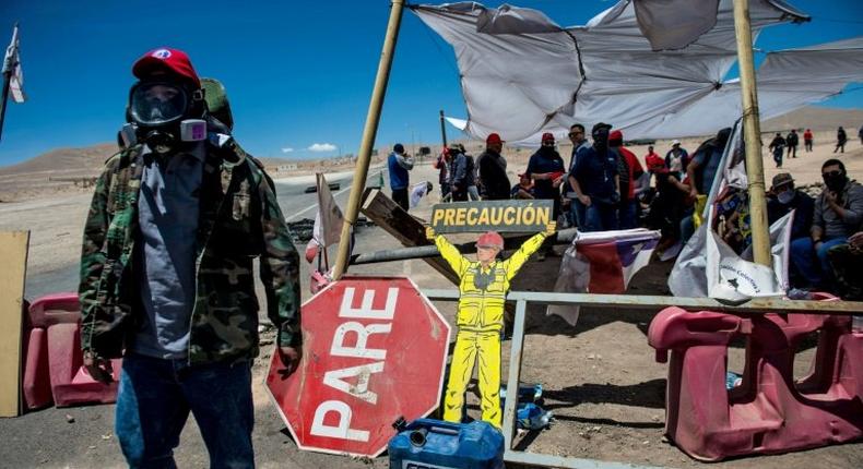 Workers of the Escondida copper mine block a road as they strike in Antofagasta, Chile, on February 15, 2017