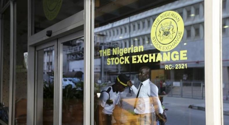 A security officer checks a man outside the Nigerian Stock Exchange in Lagos April 8, 2014. REUTERS/Akintunde Akinleye