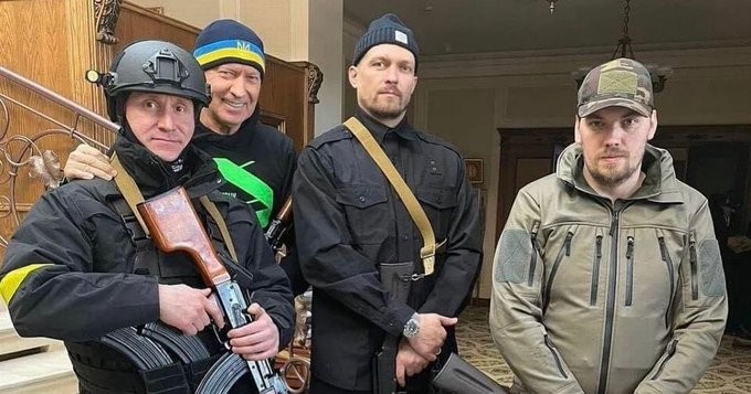 Usyk (2nd from right) returned to defend Ukraine from Russian Invaders in February 