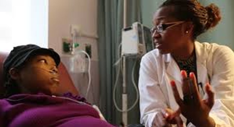 A nurse attending to a sickle cell patient.