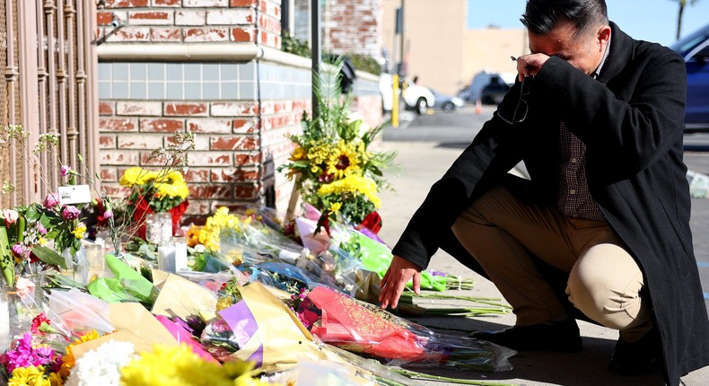 Monterey Park mayor Henry Lo kneels at a makeshift memorial outside the scene of a deadly mass shooting at a ballroom dance studio on January 23, 2023 in Monterey Park, California.Mario Tama/Getty Images