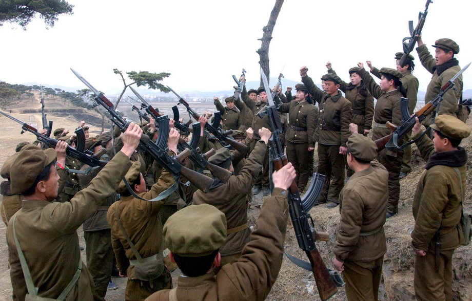 Members of the Worker-Peasant Red Guards, the civilian forces of North Korea, shout slogans in an undisclosed location.