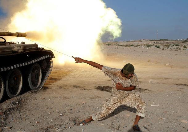 A fighter of Libyan forces allied with the U.N.-backed government fires a shell with Soviet made T-5