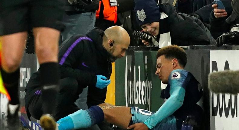 Tottenham midfielder Dele Alli receives medical attention at Craven Cottage
