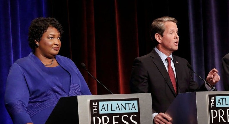 Georgia Republican gubernatorial nominee Brian Kemp speaks as Democratic gubernatorial nominee Stacey Abrams looks on during a debate in Atlanta on October 23, 2018.