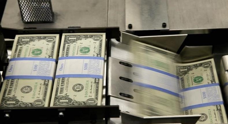 United States one dollar bills are put in packaging bands during production at the Bureau of Engraving and Printing in Washington November 14, 2014.   REUTERS/Gary Cameron