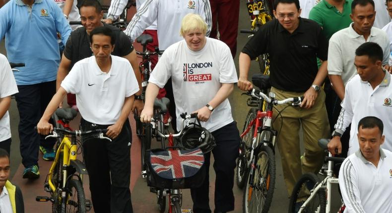 Boris Johnson, seen in his mayor of London days on a visit to Jakarta, says the coronavirus is a 'wake-up call' to the risks of being overweight and junk food advert bans and more biking can help tackle the issue