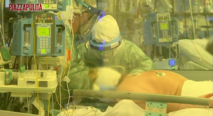 Medical staff in protective suits treat coronavirus patients in an intensive care unit at the Cremon