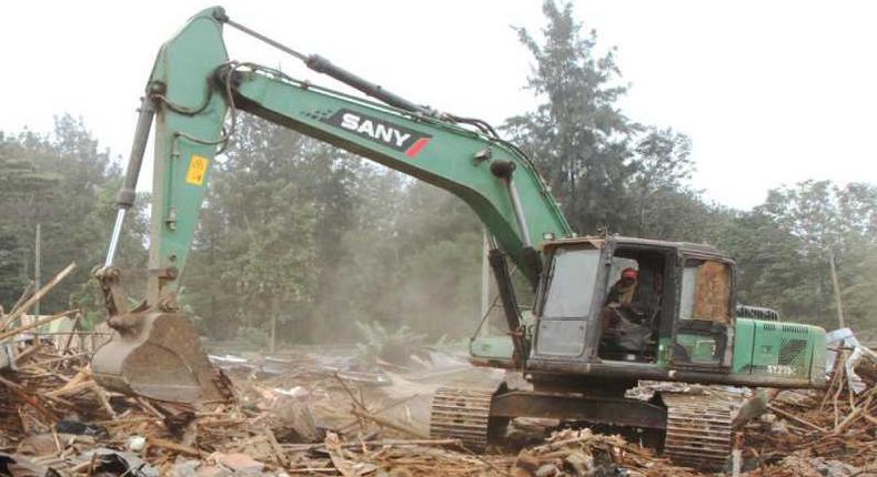 A bulldozer demolishing a building