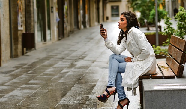 stock-photo-portrait-of-beautiful-young-woman-in-urban-background-talking-on-phone-170863106