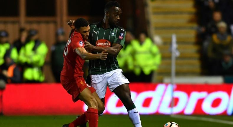 Plymouth Argyle striker Jordan Slew is tackled by Trent Alexander-Arnold in an FA cup match in 2017 - Plymouth have raised the money to commemorate Jack Leslie, a black player from the 1920s
