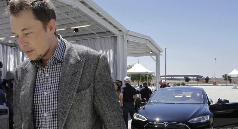 Tesla CEO Elon Musk walks past the Tesla Model S in Fremont, California.