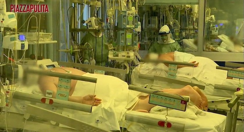 Medical staff in protective suits treat coronavirus patients in an intensive care unit at the Cremon