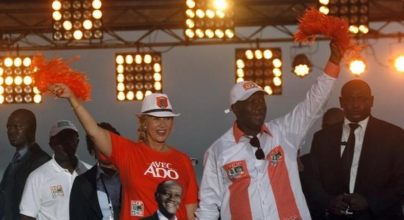 Ivory Coast's President Alassane Ouattara of the Rally of the Houphouetists for Democracy and Peace (RHDP) party and his wife Dominique Ouattara  wave during his last campaign rally , ahead of the October 25 presidential election, in Abidjan on October 23,2015. REUTERS/Luc Gnago