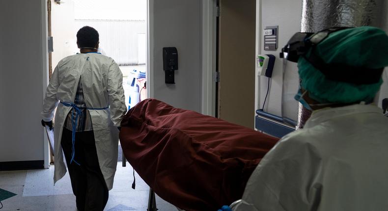 Medical staff push a stretcher with a deceased patient out of the COVID-19 intensive care unit at the United Memorial Medical Center on June 30, 2020 in Houston, Texas.

