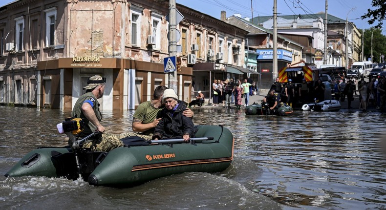 Officials help people to evacuate their homes after the explosion at the Kakhovka hydropower plant that flooded houses and streets in Kherson, Ukraine on June 7, 2023.Ercin Erturk/Anadolu Agency via Getty Images