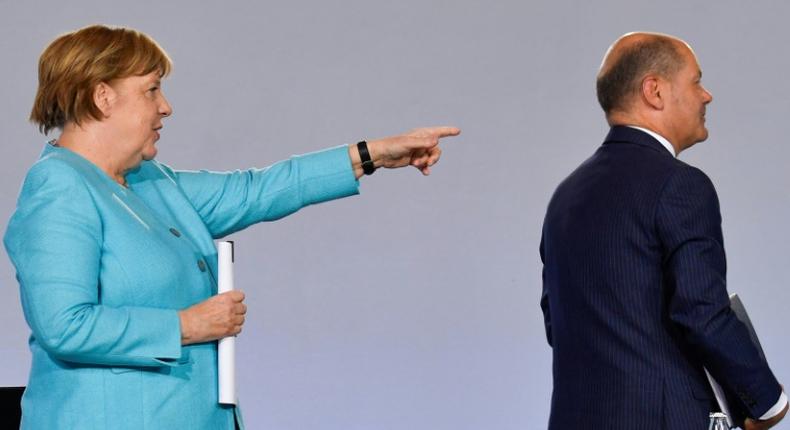 German Chancellor Angela Merkel points to Finance Minister Olaf Scholz after announcing the new stimulus package