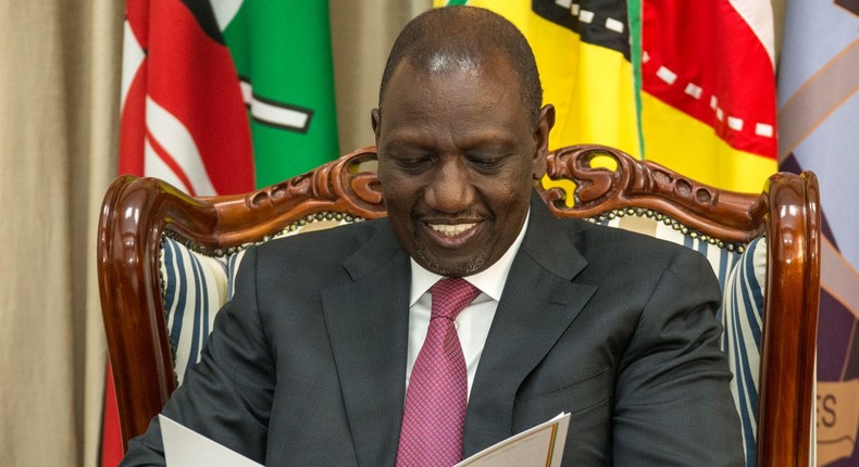 President William Ruto peruses through a document at State House