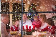 Family enjoying Christmas dinner at home in decorated room