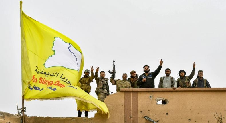 Syrian Kurdish fighters raise their flag in March after overrunning the last vestige of the Islamic Strate group's caliphate in a US-backed offensive they had hoped would earn them Western support for their dreams of self-rule