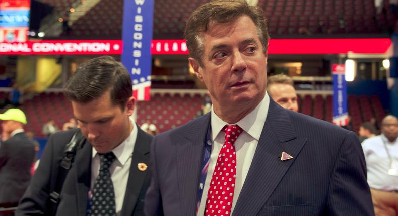 In this July 18, 2016, file photo, Trump campaign chairman Paul Manafort walks around the convention floor before the opening session of the Republican National Convention in Cleveland.