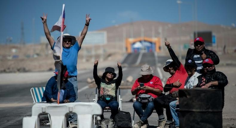 Miners of the Escondida copper mine, on strike, blocking a road outside of Escondida, some 145 km northeast of Antofagasta, Chile, on March 8, 2017