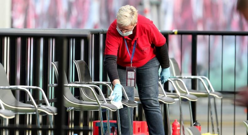 A member of staff cleans the substitute bench during half time of RB Leipzig's draw with Hertha Berlin