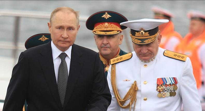 Russian President Vladimir Putin (L) and commander-in-chief of the Russian Navy Nikolai Yevmenov (R) attend Navy parade marking Russian Navy Day in St. Petersburg, Russia on July 31, 2022.