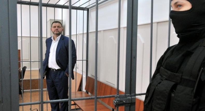 Nikita Belykh, accused by Russia's Investigative Committee of accepting a bribe of 400,000 euros ($430,800), stands inside a defendants' cage during a hearing at the Basmanny district court in Moscow on June 25, 2016